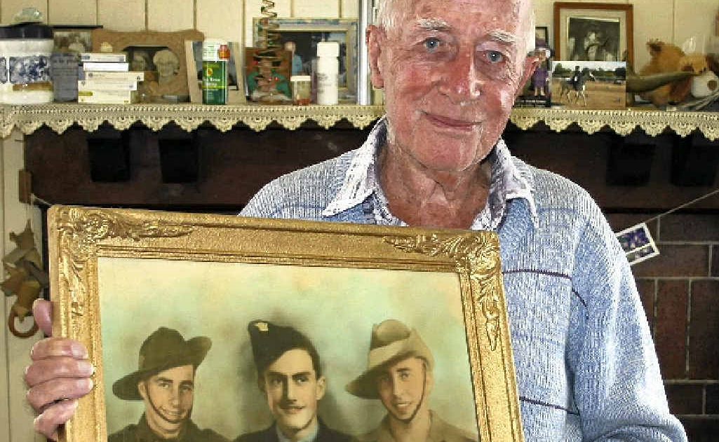 Battle of Milne Bay veteran Len Acworth with a photo of himself and two brothers during the Second World War, (from left) his twin Ernie, younger brother Syd and Len. Battle of Milne Bay veteran Len Acworth with a photo of himself and two brothers during the Second World War, (from left) his twin Ernie, younger brother Syd and Len.